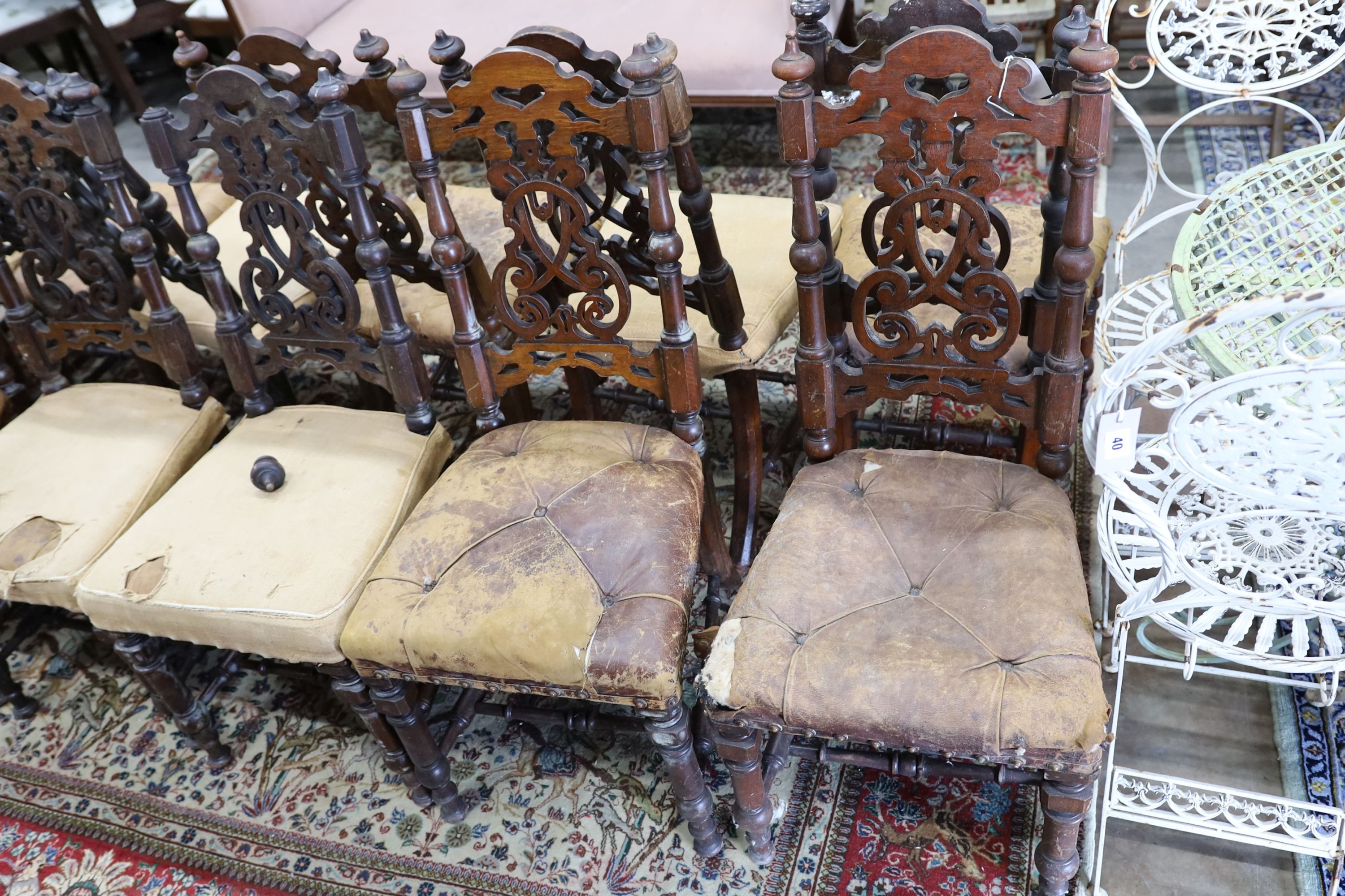 A set of fourteen 19th century Continental carved oak dining chairs